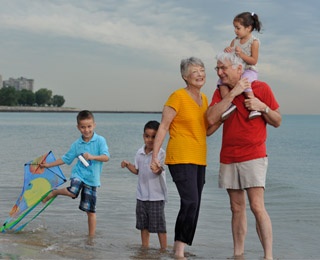 grandparents with grandkids on beach